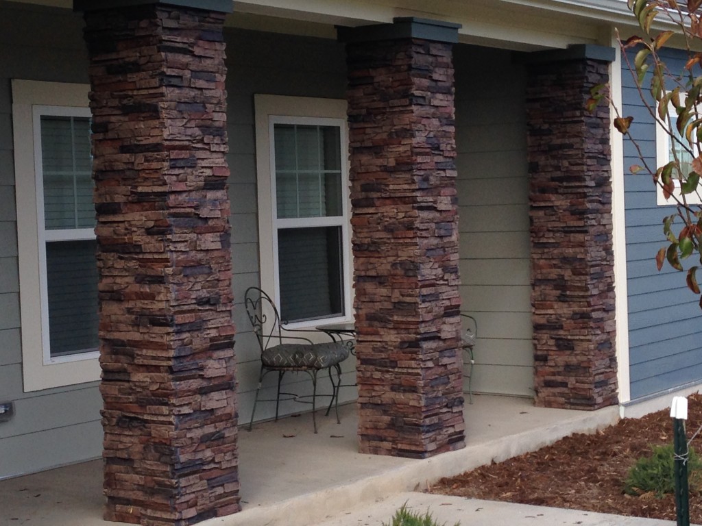 Decorative pillars lined in a colonnade on a porch create an inviting ambiance.