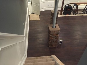 Basement pillars wrapped in faux stone with caps