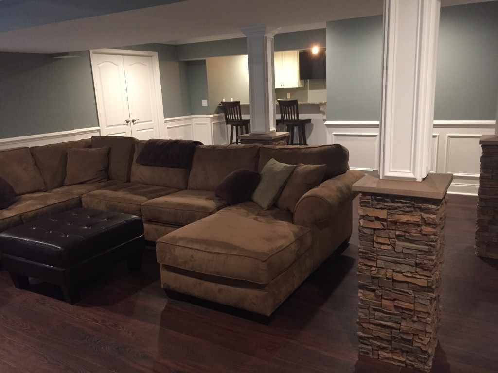 Super stylish basement columns that mimic the look of real stacked stone.