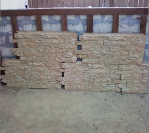Faux stone wall siding lined up before installation