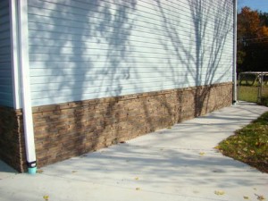 Dry stack wainscoting panels are installed on this home's exterior, transforming the look of the house.