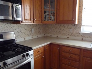  Modern appliances and cabinets clashed with dated wallpaper.
