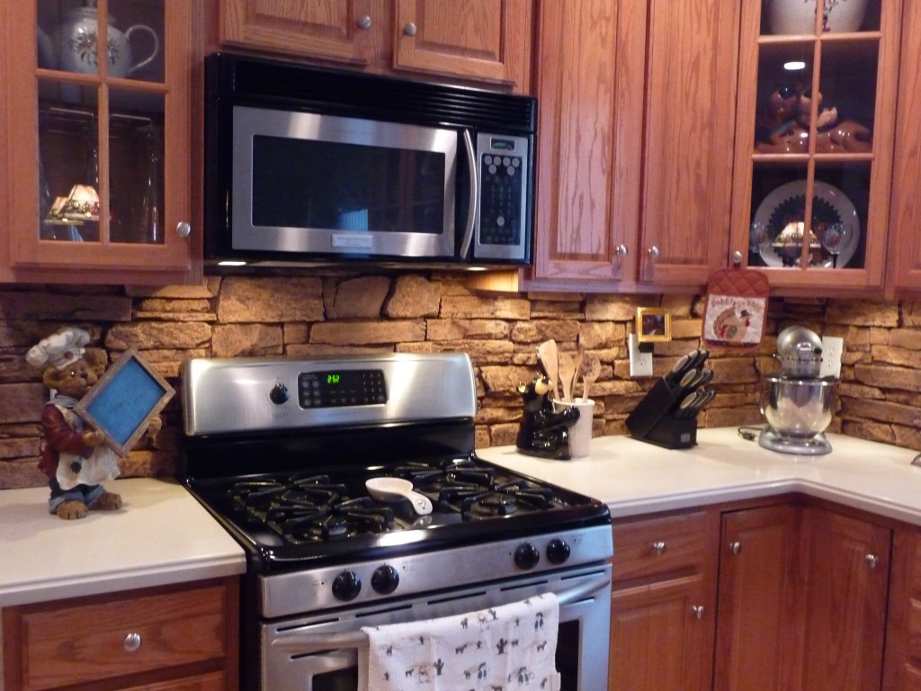 Decorative backsplash panels installed in a kitchen.