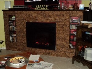 Fireplace surround build completed by homeowners using stacked stone paneling.