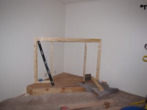 What would become a beautiful faux stone fireplace started out as a simple wooden frame. Kerby created an entire enclosure of 2x4s and plywood for his fireplace frame.