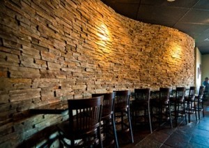 Creating a curved wall design involves expensive masonry and a lot of time, whereas faux stone panels can create the same look easier.