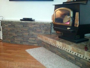 Wood stove platform covered in drystack stone style panels.