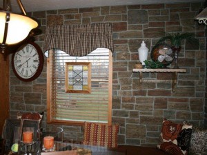 Kitchen wall remodeled with ledgestone paneling for a French country farmhouse look.