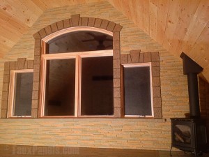 Keystones and trim blocks frame a large picture window.