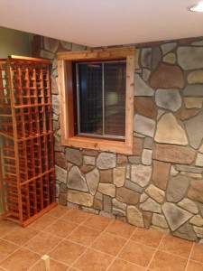 Fieldstone style paneling installed around a basement window