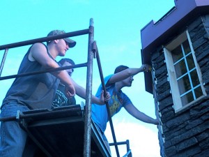 Venture Crew 630 members installing siding to the Enchanted Castle of Dreams