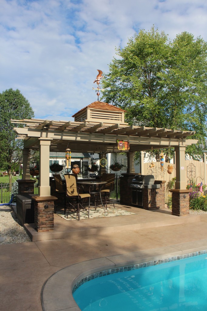 Building a pergola with stacked stone veneer column supports adds beauty.