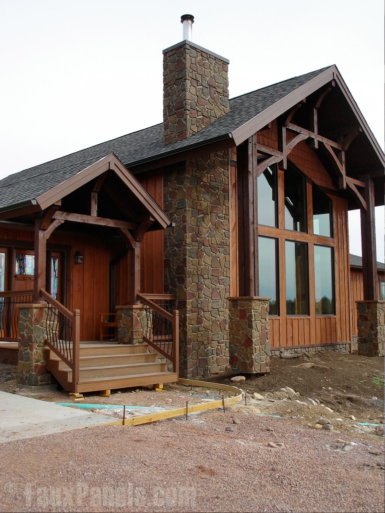 Fieldstone chimney and column siding contrasts beautifully with this home's wooden truss and wood siding to create a rustic modern appearance.