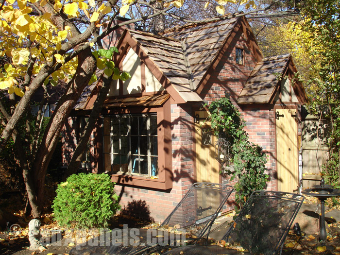 Fake brick panels create the look of traditional masonry to this cottage.