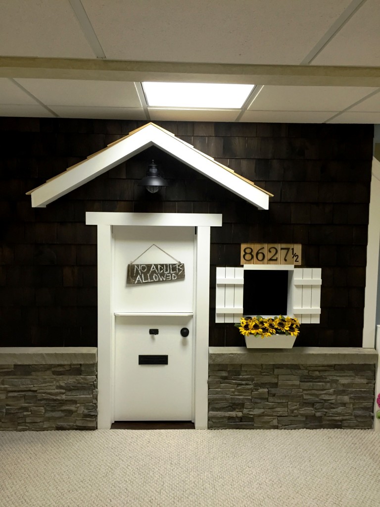 Imitation stacked stone panels give a kids' playhouse beautiful wainscoting.