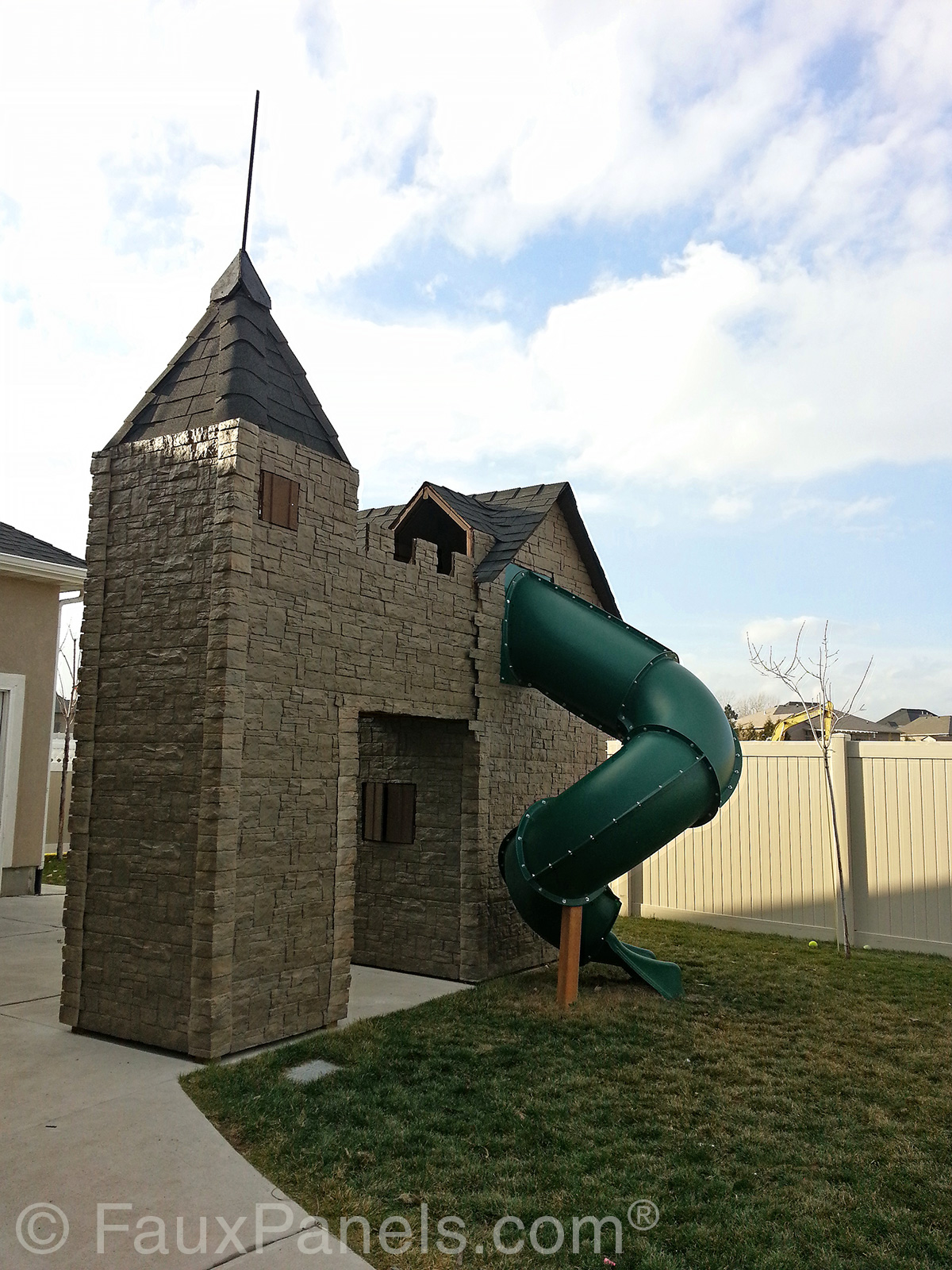 Castle style backyard playhouse with tub slide