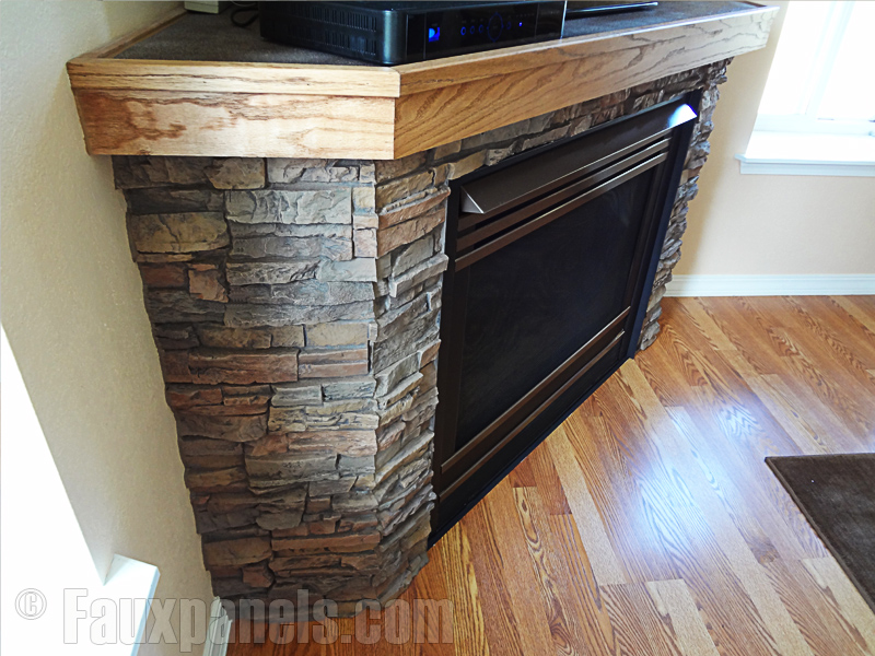 A corner fireplace surround made of stacked stone veneer is a great way to add comfort to a living room.