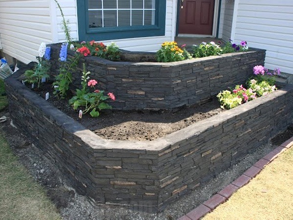 This multi-tiered flower bed is beautifully enhanced with stacked stone panels