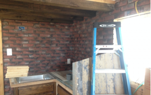 Lightweight, artificial brick panels installed in a tiny house kitchen.