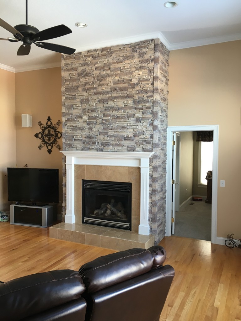 Gorgeous fireplace facing made with polyurethane panels that mimic the look of real stacked stone.
