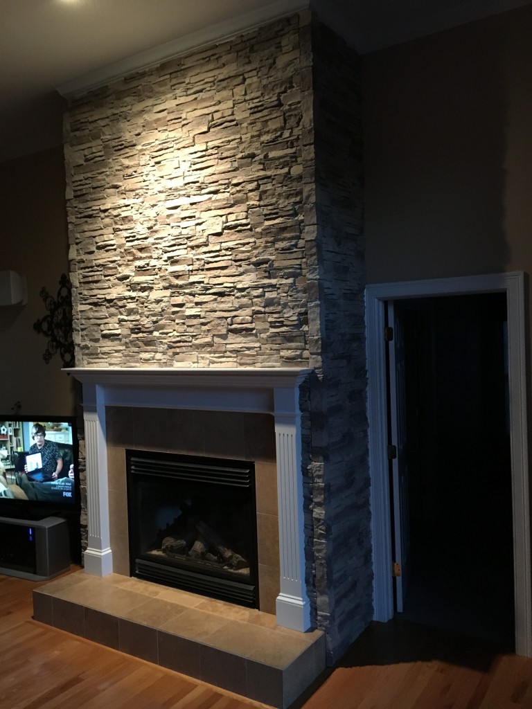Faux stacked stone fireplace facing project complete