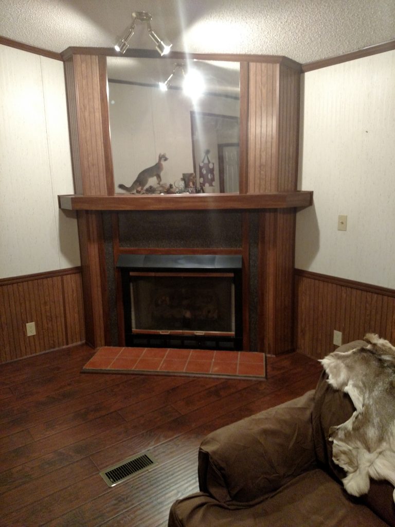 BEFORE: The dark wood wainscoting looked old fashioned and dated.