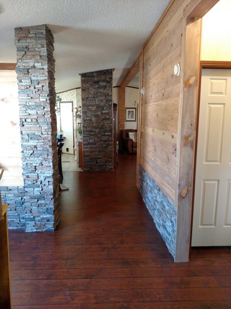 Polyurethane stacked stone panels covering a home's old wainscoting and support columns.