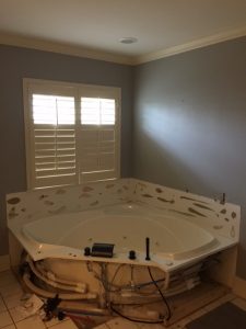  BEFORE: The tub was installed against standard drywalling.
