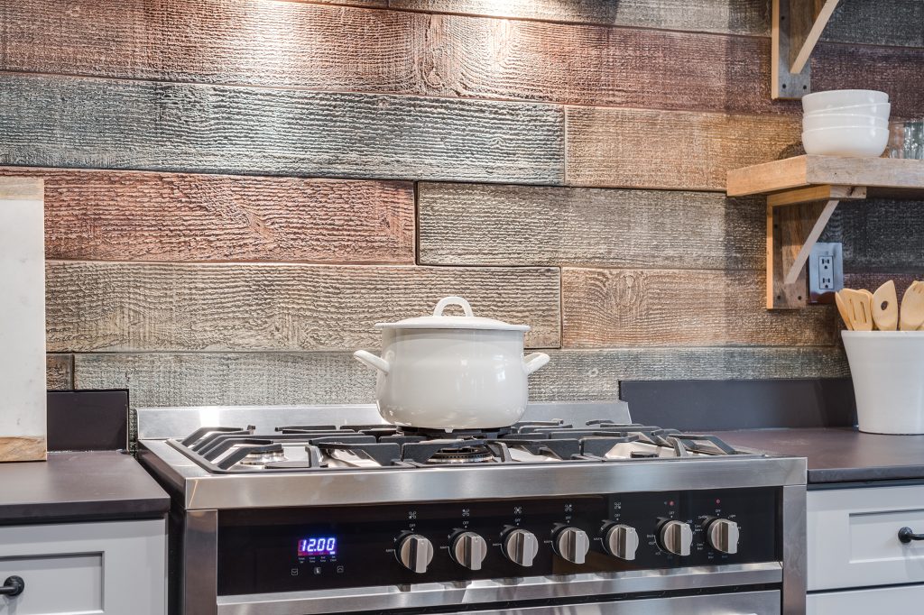 Kitchen stove area with backsplash created from Reclaimed Barn Board panels - featured on the Home Free TV show.