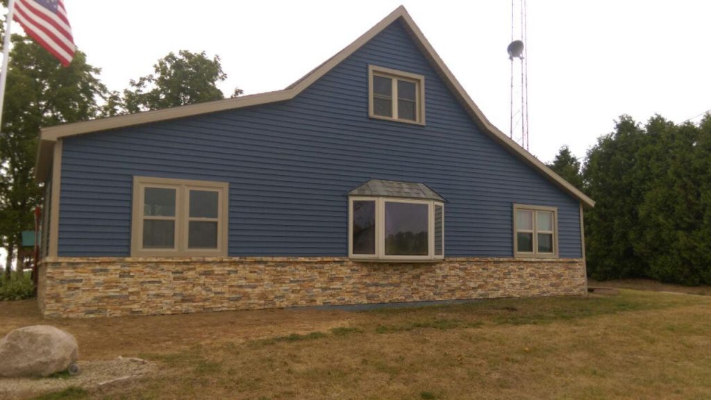 Exterior home renovation project featuring new Wellington Drystack siding on the lower half of the house.