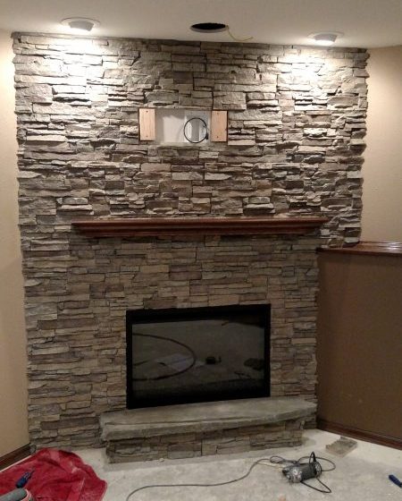 New fireplace veneer created with stacked stone style panels