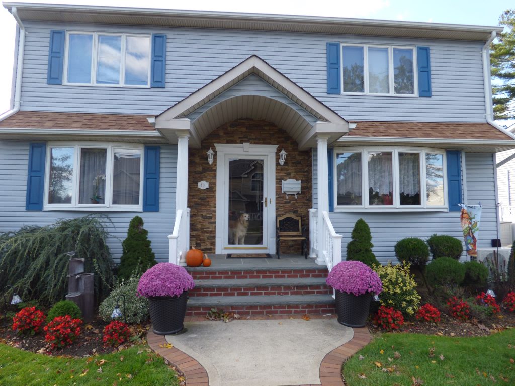 AFTER: A home's front entrance re-sided with stacked stone style panels.