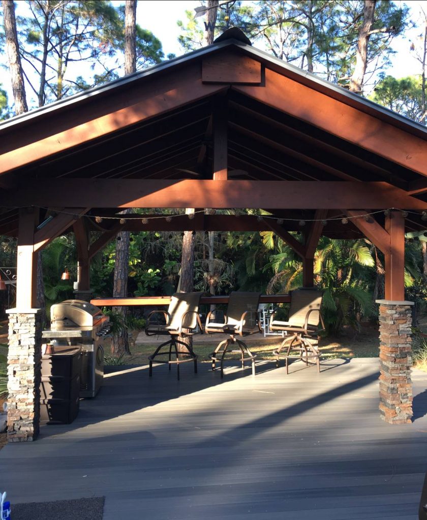 Backyard pavilion with faux stacked stone columns on the 4 supporting posts.