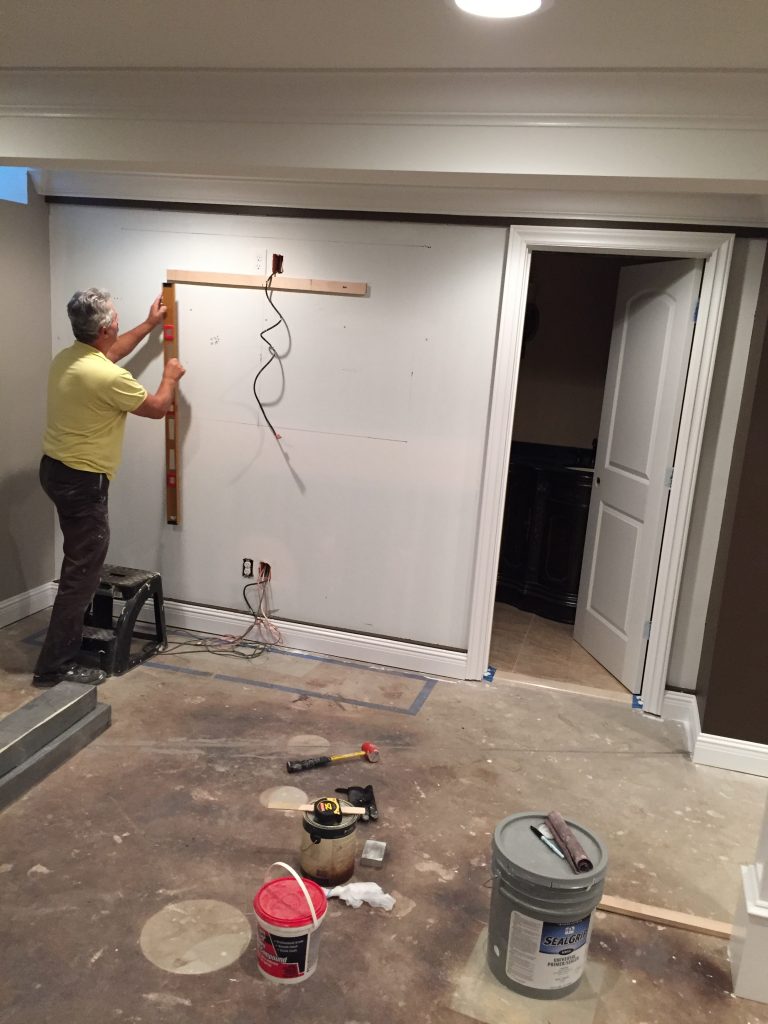 Beginning the remodel of a basement wall.