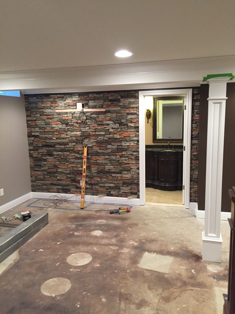 Basement wall covered in seamless, dry stack style panels ==.