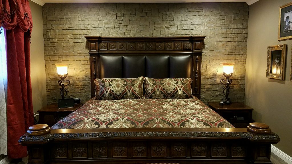 Romantic bedroom remodel with new stone-style focal wall.