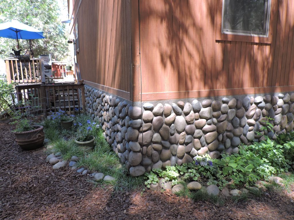 The River Rock style of siding best suited the house's landscaping and location.