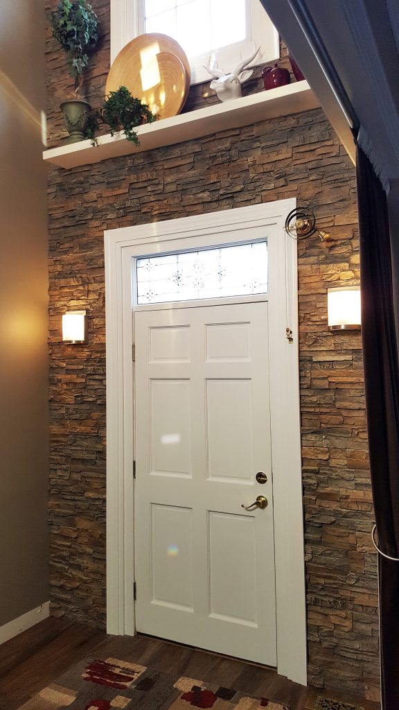 DIY accent wall created with Regency Stacked Stone panels around a home's front doorway.