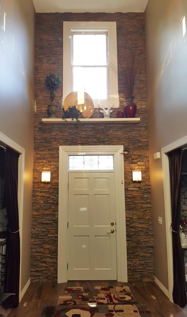 Doorway accent wall with light fixtures and decorative shelf