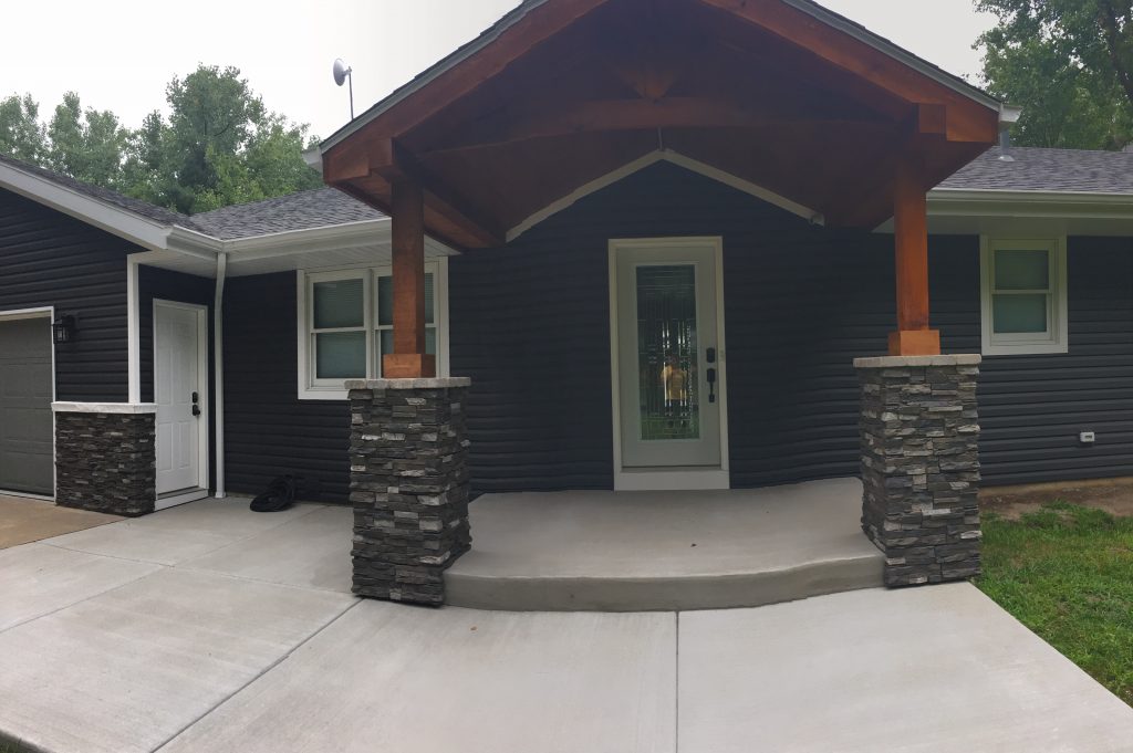 AFTER: New front porch with stacked stone-style column bases.