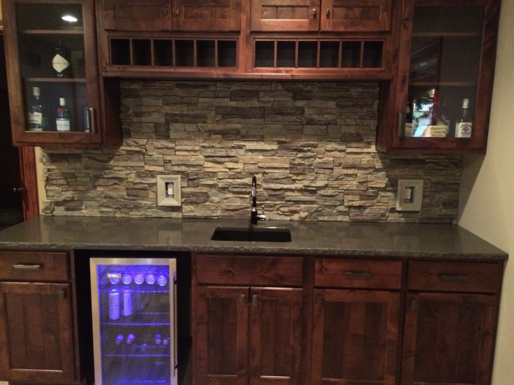 Man cave bar with new backsplash created with Regency Stacked Stone panels and matching outlet covers.
