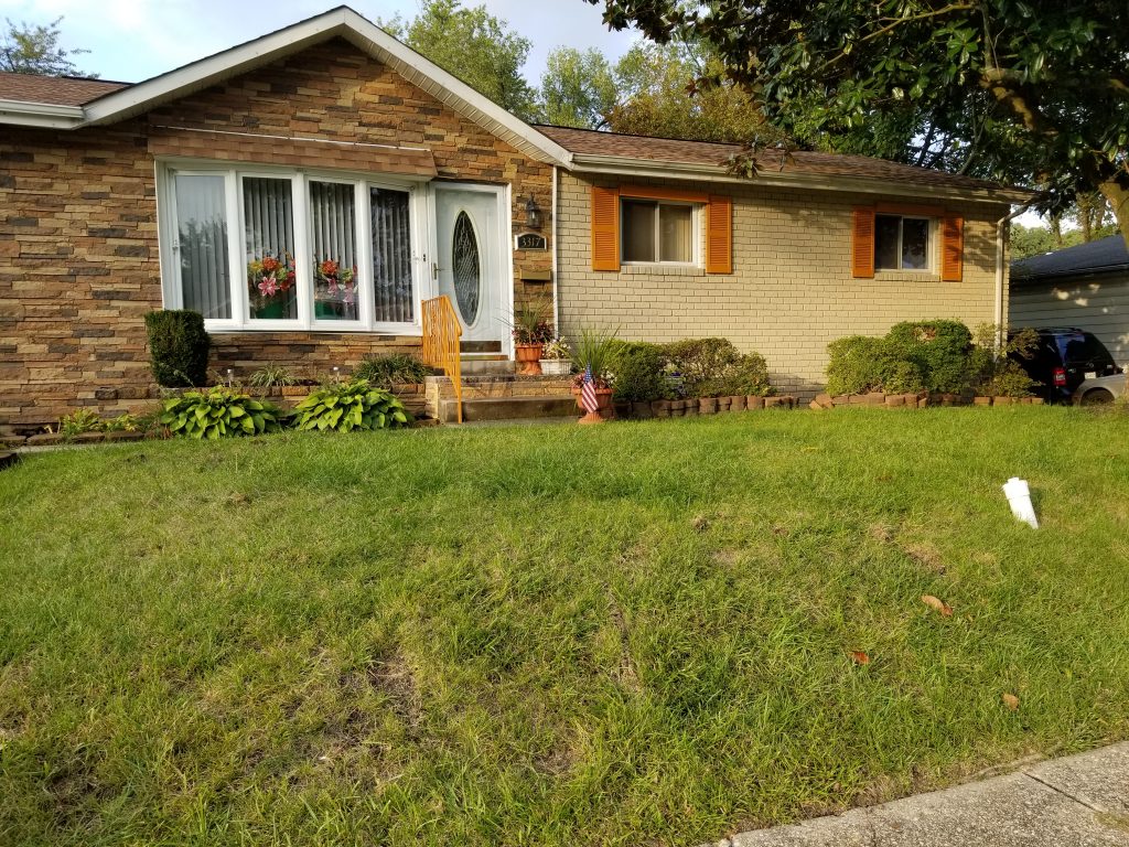 Dee added instant curb appeal to her brick home by installing Norwich Stone Wall panels on half of the exterior.