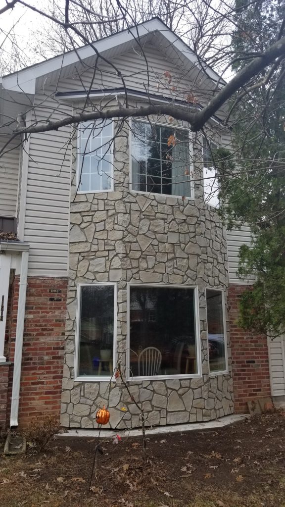 A home's bay window exterior design enhanced with Carlton Fieldstone panels.