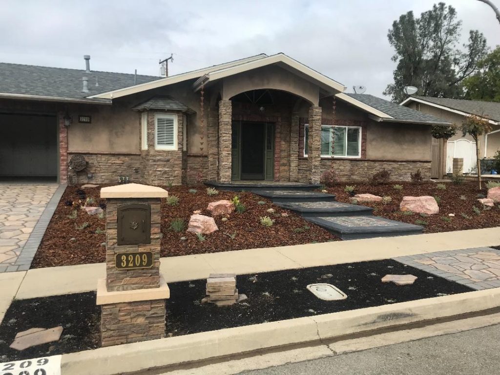 The new mailbox enclosure pairs perfectly with the home's existing stonework.