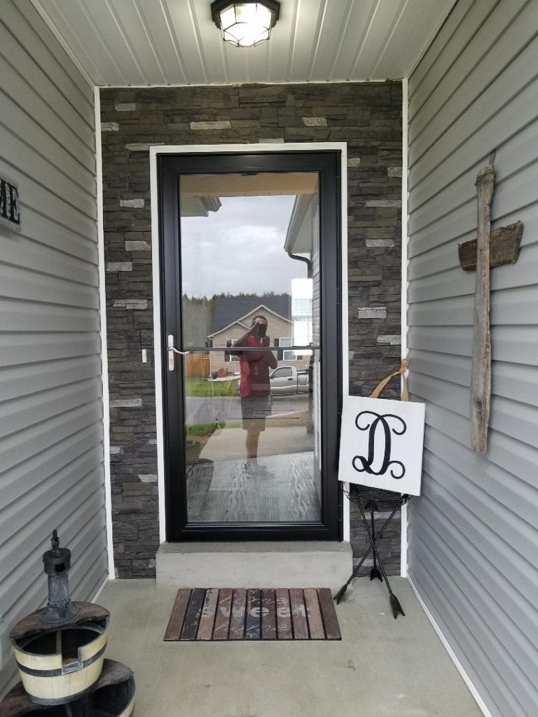 Framing an exterior door with stacked stone style panels makes a big design impact.