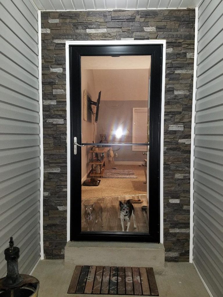 The finished doorway with faux stone panels