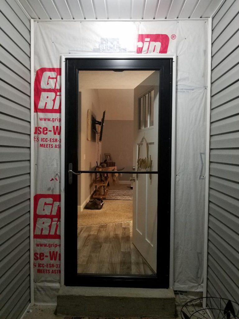 In progress image of the doorway with housewrap for underneath the stone panels