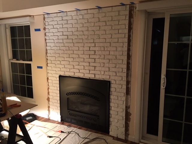 Allan cut the panels to fit around the recessed fireplace.