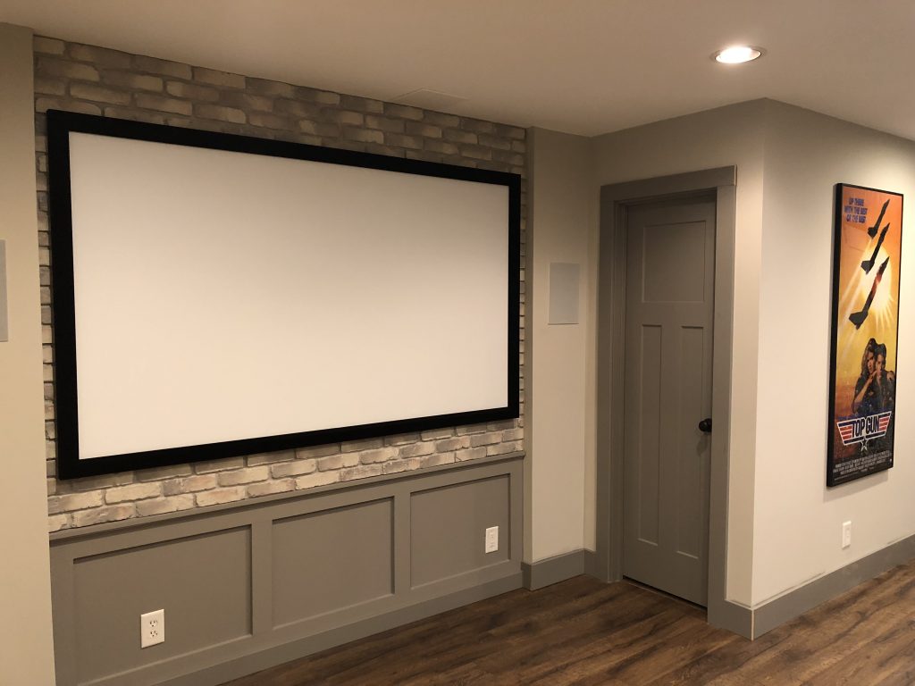 Grey wainscoting and baseboards contrast with taupe walls, and balance the Cream Caramel brick perfectly.