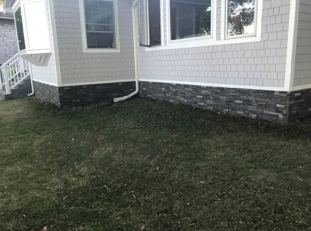 This mobile home looks like it's sitting on a real stone foundation